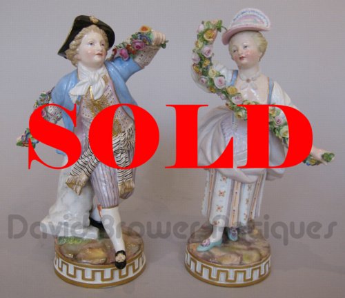 Pair of Meissen figures of a gallant and companion with floral garlands