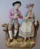 Meissen group a boy offering flowers to a girl