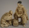 A fine Japanese ivory group of seated Samurai with 2 women