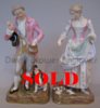 Pair of Meissen figures depicting a couple feeding a dog and some doves